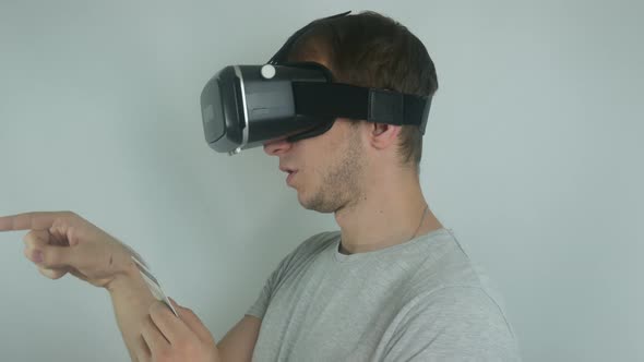 Man In A Modern Helmet Of Virtual Reality Uses A Credit Card