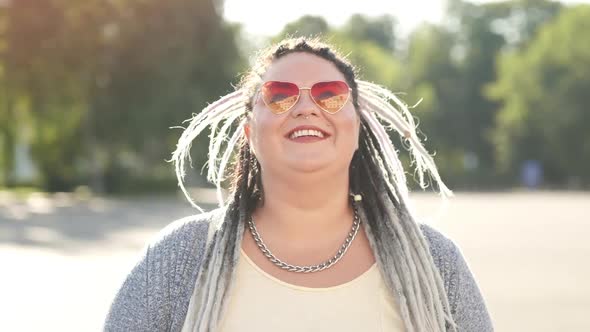Close-up Portrait of Joyful Young Woman with Bright Hair, Pink Colorful Glasses Cute Face and Dental alt