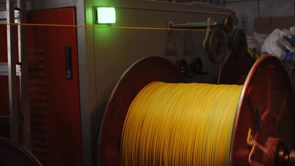 Spinning Reel with Yellow Cable in Cable Production Closeup