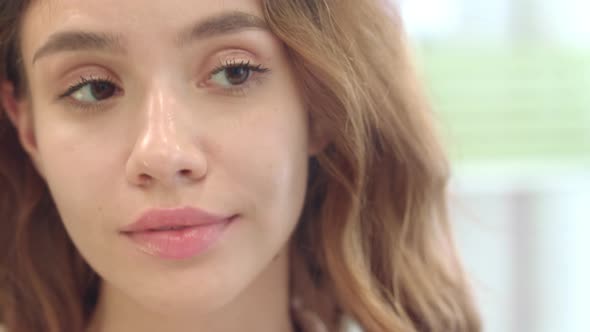 Happy Woman Using Mascara Brush for Eyelashes Front Bathroom Mirror in Home alt
