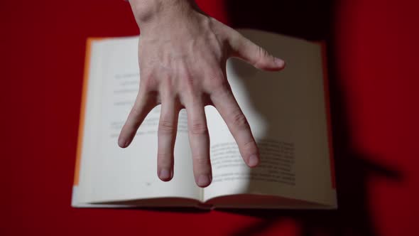 The Hand Browses Through the Pages of the Book with Telekinesis alt