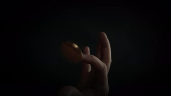 Slowmotion Shot Tossing Bitcoin to Flip on Heads or Tails alt