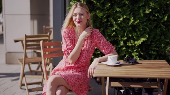 Cheerful Young Woman Resting in Cafe alt