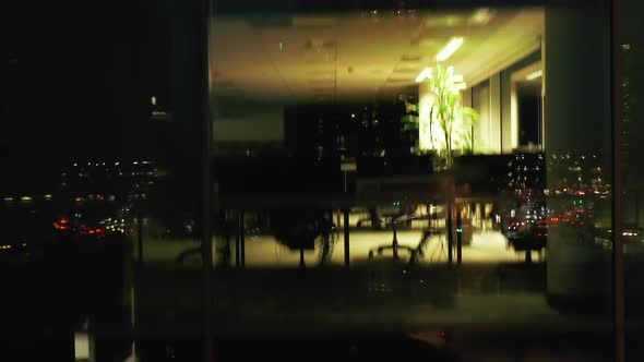 Fast Ascending Shot Along Office Windows at Night alt