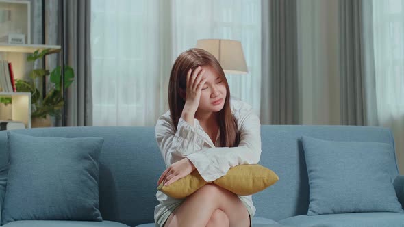 Unhappy Lonely Depressed Young Asian Woman At Home, She Is Sitting On The Couch, Depression Concept alt
