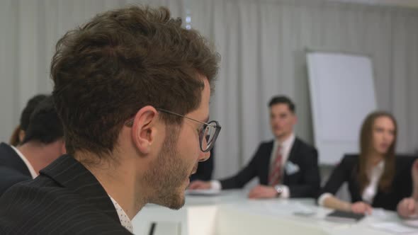 Close up of a businessman discussing in a meeting alt