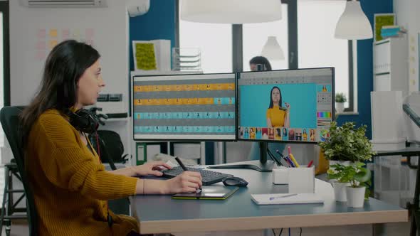 Woman Graphic Editor Retouching Photos of Client in Professional App alt