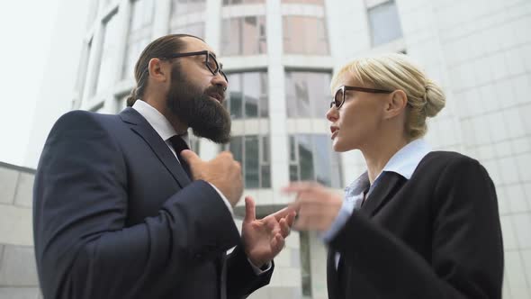 Annoyed Male and Female Colleagues Arguing, Rivalry at Work, Business Conflict