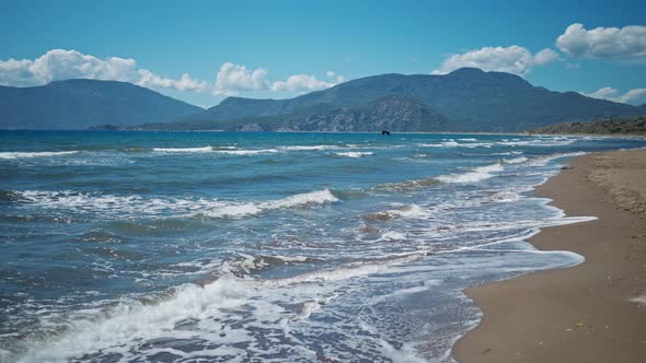 Waving Sea with Waves at Sunny Summer Windy Day at Beautiful Sandy Empty Beach Iztuzu in Turkey alt