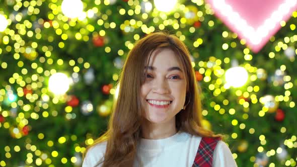 happy woman walking with Christmas tree background, x-mas celebrating