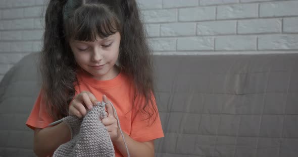 Child Knitting on Sofa alt