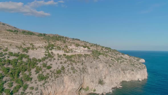 Aerial view of rocky mountain  beside the calm sea with amazing blue sky alt