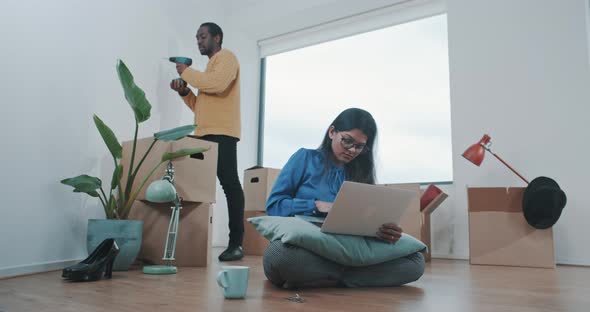 Young multi ethnic couple just moved in to new home alt