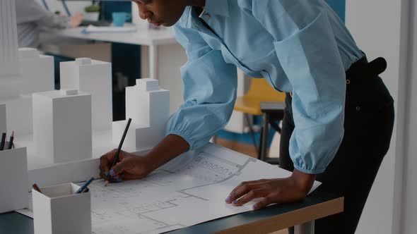 Close Up of Woman Looking at Blueprints Plans to Work on Architecture Project alt
