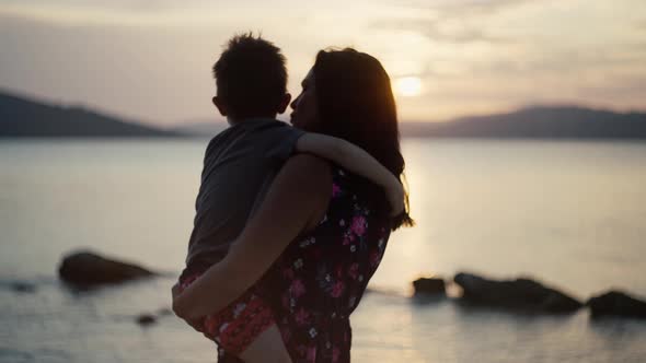 Mom with Son By the Sea at Sunset alt