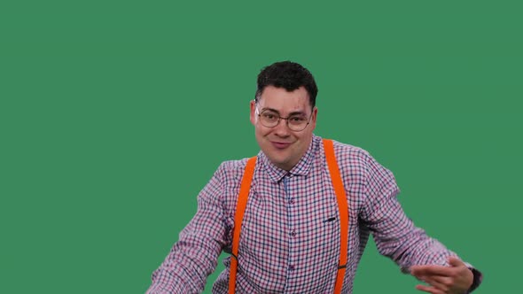 A Positive Man in Glasses in a Plaid Shirt with Orange Suspenders is Having Fun Dancing Moving alt