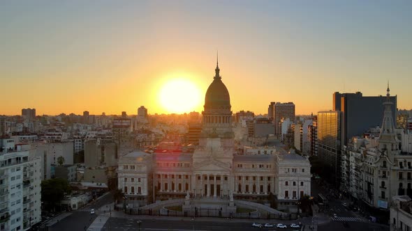 Aerial jib down over Monument of Two Corngresses in square near Argentine Congress building at golde alt