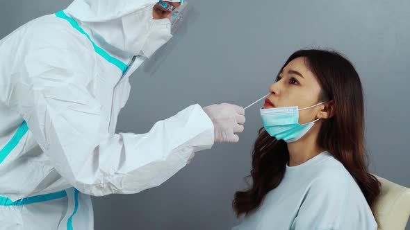 doctor with PPE suit test coronavirus(covid-19) to patient by nasal swab