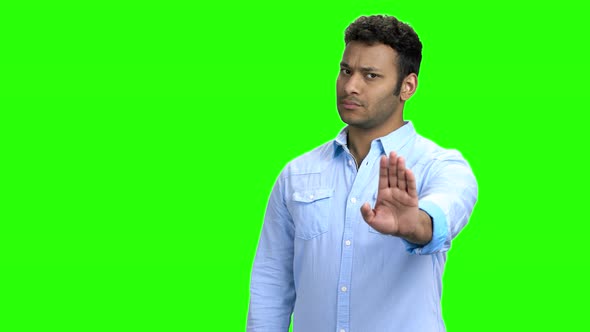 Young Confident Man Making Gesture STOP with Hand alt