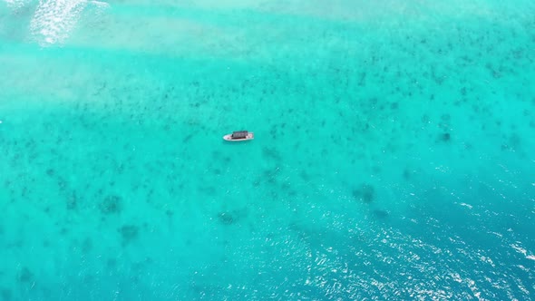 Aerial Top View of a Fishing Boat Sailing in Turquoise Waters of Ocean Zanzibar alt