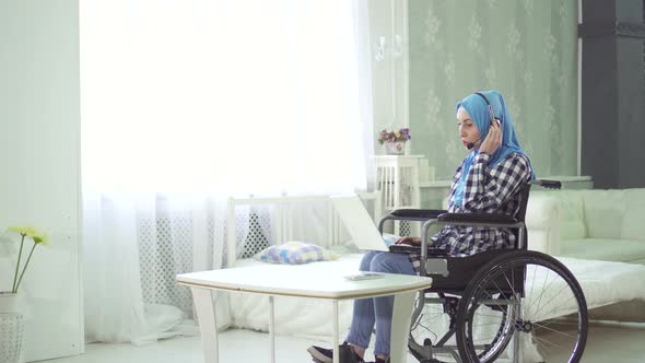 Beautiful Young Woman in Hijab Disabled Person Smiling Wheelchair Teleworking in the Internet alt