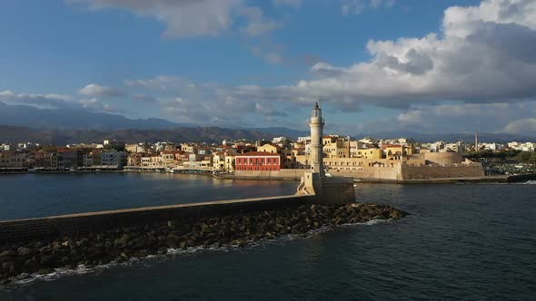 Aerial Drone Video of Iconic Venetian Lighthouse in the Entrance of Picturesque Old Port of Chania