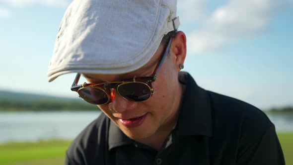 4K Asian man golfer golfing at country club at summer sunny day. alt