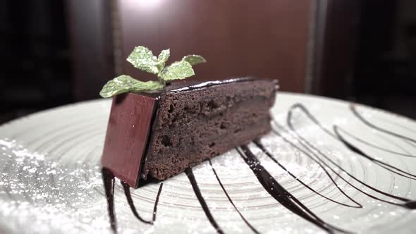 Piece of Chocolate Cake on a Beautiful Plate Spins