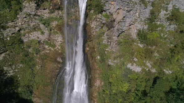 Slow Motion Flying Above the Waterfall in the Green Forest in Georgia