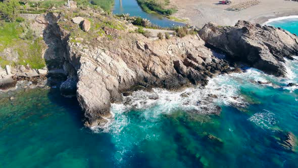 Clear Sea Beating Against High Cliifs on Coast alt