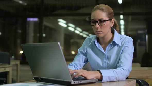 Tired Woman Checking Time on Watch, Working Overhours in Office to Meet Deadline alt