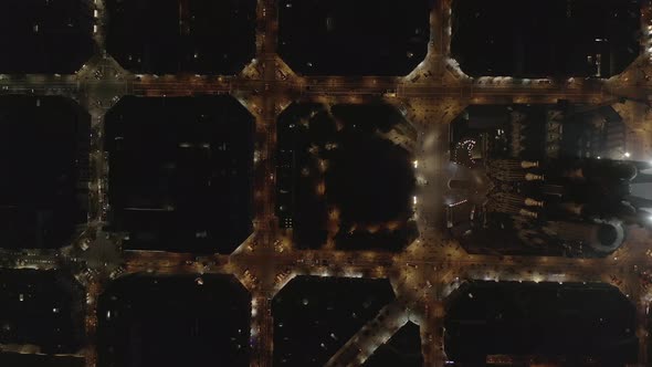 AERIAL: Barcelona Overhead Drone Shot of La Sagrada Familia at Night with Beautiful City Traffic alt