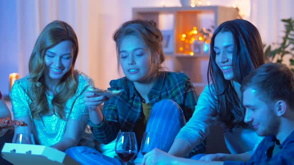 Friends Eating Pizza and Drinking Wine at Home  alt