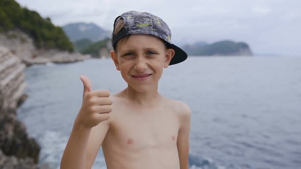 Portrait of a Cute Smiling Boy in Peaked Cap alt