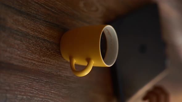 A Yellow Mug of Steaming Coffee