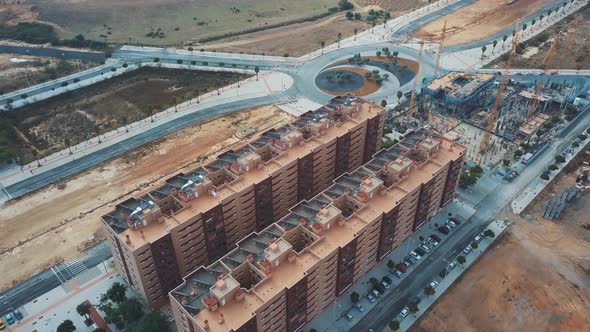 Aerial view of a new building in the outskirts of a city. alt