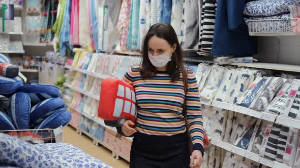 Female in Protective Mask Buying Pillow for Home alt
