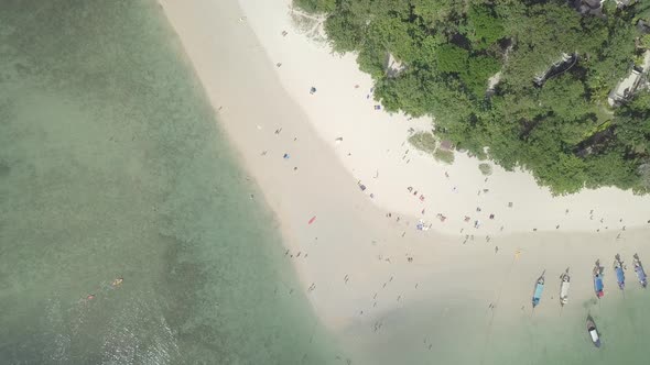 Aerial view of sunbathing swimming people relax on Phra Nang beach. Thailand alt