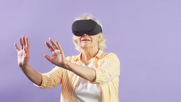 Slow Motion Very Old Grandma, Dressed Fashionably and Youth Use VR Glasses. Isolated Background alt
