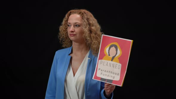 Confident Woman Presenting Planned Parenthood Funding Program Holding Banner in Hand Smiling to alt