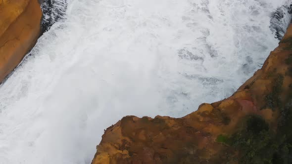 Wildlife Coastline with Crushing Waves Against the Rocks Overhead Aerial View alt