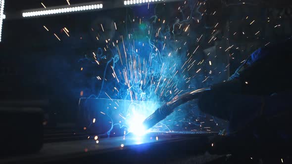 Closeup Slow Motion Welding of a Metal Part in an Auto Repair Shop