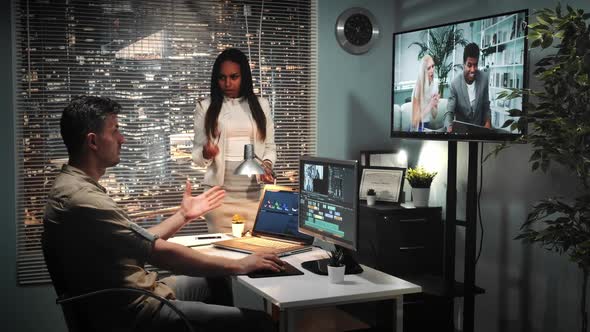 African-american Chief Director Showing Unsatisfied Emotions To Video Editor's Project alt