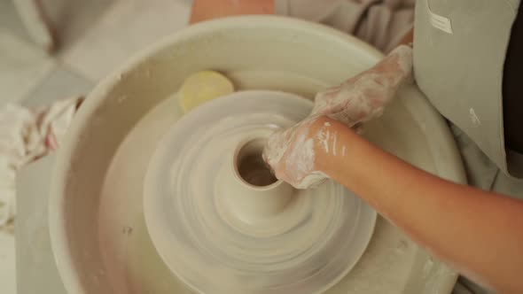 Female Master Creating Pottery in Workshop