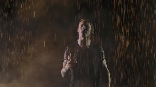 Lead Singer of a Rock Band Sings Emotionally in Dark Studio with Yellow Light alt