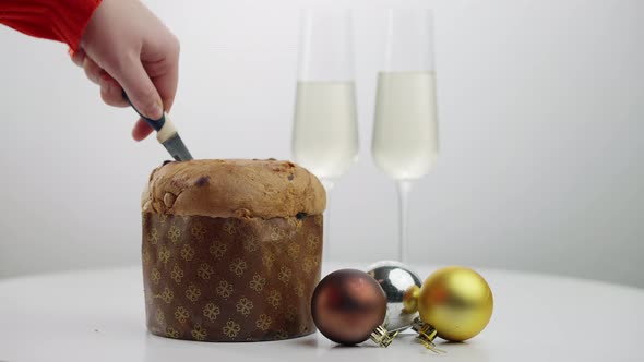 Closeup Christmas Bread with Young Female Hand Cutting Traditional Pastry alt