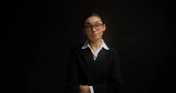 Striking Brunette in Glasses and a Business Suit Yawns
