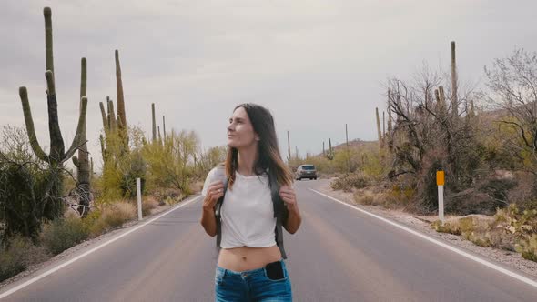Slow Motion Young Beautiful Happy Tourist Woman Walking Towards Camera Along Cactus Desert National alt