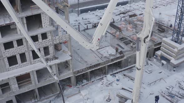 A Drone View of the Construction of a Residential Building Using a Concrete Pump alt