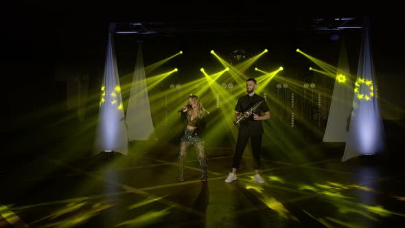 Musical Group Band of Singer Woman Saxophonist Sax Man Playing Music Song Performing on Stage alt